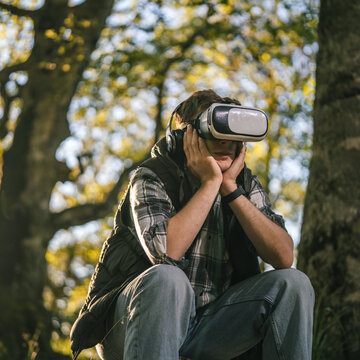 Man experiencing virtual reality outdoors in technology escape