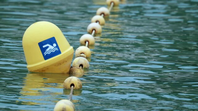 Yellow swimming buoy with a no swimming icon, marking a restricted area for safety in the water