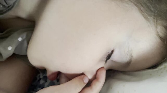 Extreme close-up of a sleeping toddler girls face, focus on delicate skin and eyelashes