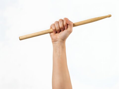 Close-up of hand holding bamboo drumstick for percussion instrument playing or music lesson