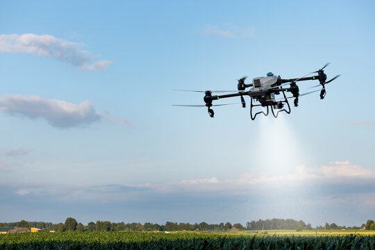 Agricultural spray drone flying over crop field for smart precision farming. Pesticide, fertilizer application