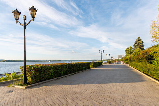 Quiet riverside promenade with blue sky and Volga view