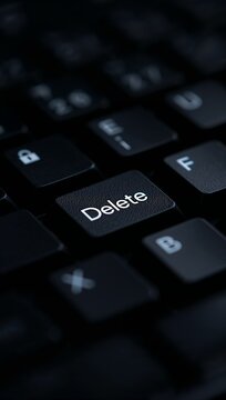 Computer keyboard with a highlighted Delete key symbolizing data removal, digital security, file management and modern computing.