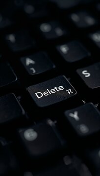 Computer keyboard with a highlighted Delete key symbolizing data removal, digital security, file management and modern computing.
