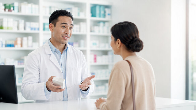 Professional pharmacist consulting customer in modern pharmacy