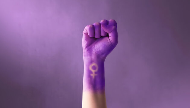 Purple painted fist with female gender symbol for feminism