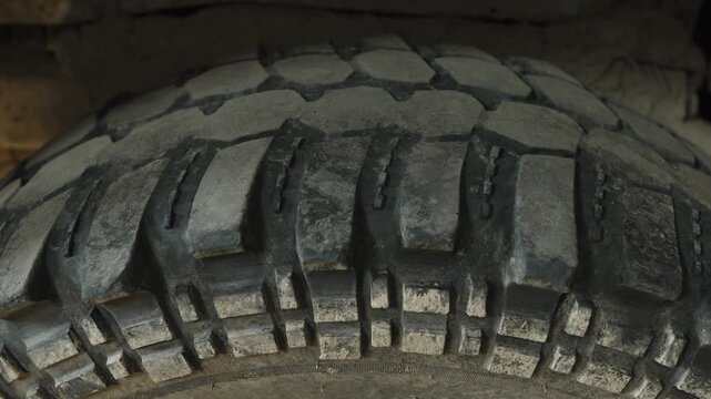 A close-up shot of a heavily textured off-road car tire.