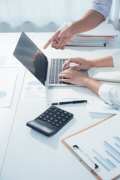 Woman hands typing on computer keyboard in modern office setting at work
