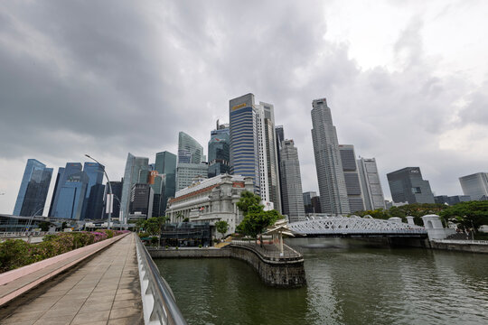 Singapore - Jan 21, 2026: A wide-angle view of the Singapore River, the historic Fullerton Hotel, and the central business district skyscrapers under cloudy skies.