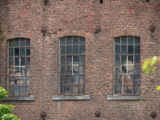 Naklejka premium Close Up of Weathered Windows on Abandoned Belgian Factory