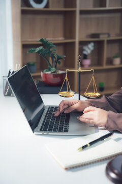Lawyer Working on Laptop with Legal Symbols in Background 