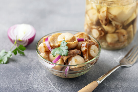 Homemade pickled mushrooms in glass bowl on the  table. Fermented healthy food.