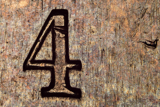 Microscopic detail of the number 4 engraved on a 1974 French 50 francs coin under microscope