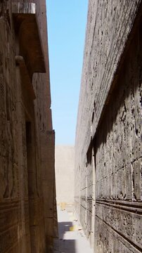 Mystical corridors with hieroglyphs and images of Egyptian gods in the Ancient Egyptian Temple of Edfu. Edfu is the site of a Ptolemaic-era Temple of Horus and an ancient settlement in Egypt