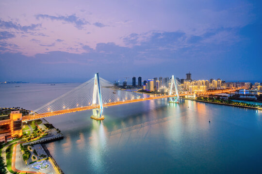 High angle night view of Century Bridge over Haidian River in Haikou, Hainan, China