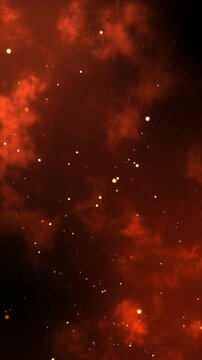 Fiery orange glowing flying ember particles on black vertical background. Burning red hot sparks rise from light fire loop background of bonfire.