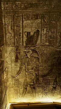 Mystical corridors with hieroglyphs and images of Egyptian gods in the Ancient Egyptian Temple of Edfu. Edfu is the site of a Ptolemaic-era Temple of Horus and an ancient settlement in Egypt