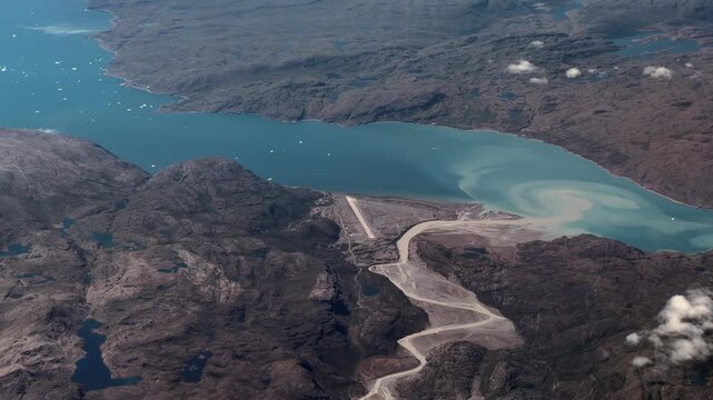 flying across Greenlandic landscape in the Kujalleq municipality in southern Greenland, with Narsarsuaq Airport (IATA: UAK, ICAO: BGBW) and Tunulliarfik Fjord surrounded by mountain landscape around