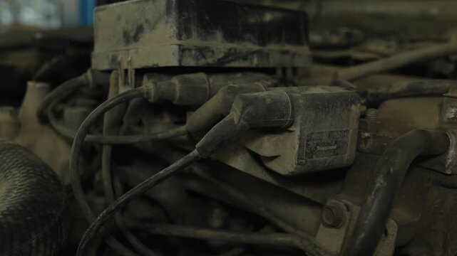 A dusty ignition coil pack with spark plug wires attached.