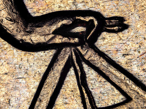 Microscopic detail of a female hand holding a balance on a 1974 French 50 francs silver coin