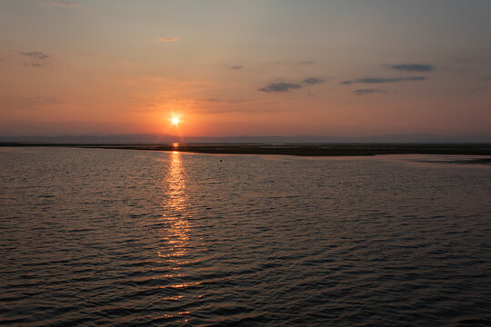 Peaceful sunrise over the Adriatic Sea at Grado Pineta, Friuli Venezia Giulia, Italy