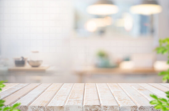 Selective focus.White rustic wood table top with kitchen background for design product