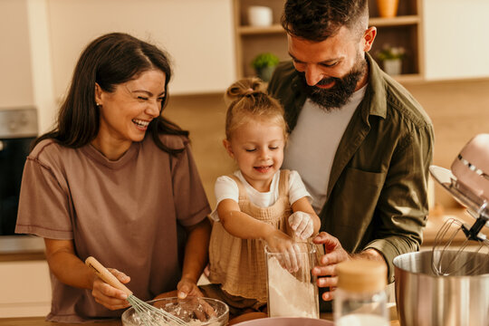 Happy family bonding, making dessert and having fun at home