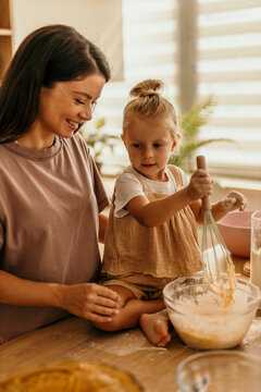 Mother and child baking together in kitchen