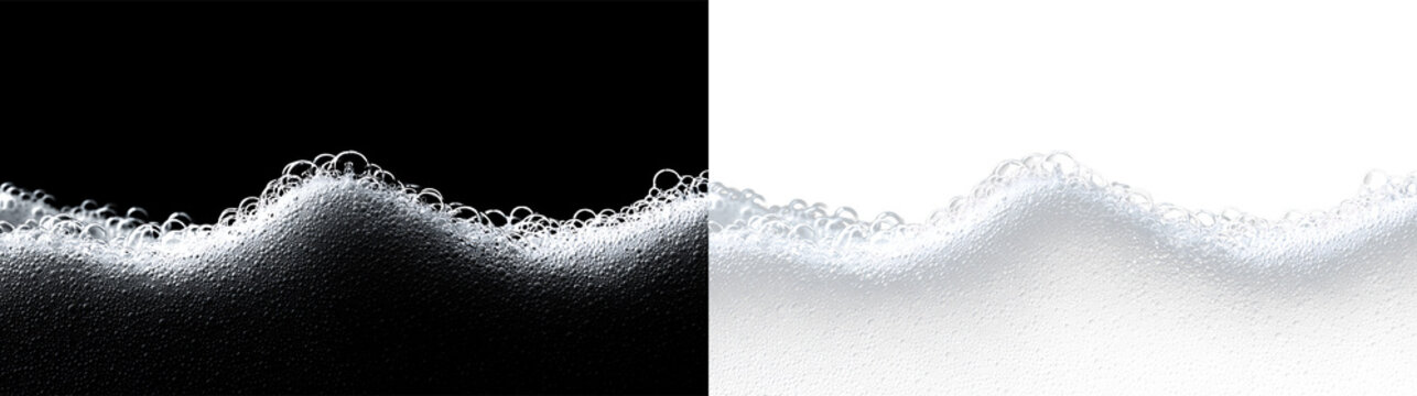 Foam curls form on the surface of liquid with bubbles floating in clear space during a close-up shot