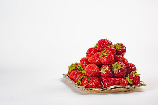 Ripe strawberries on a vintage tray on a white background. Vitamin C. Copy space. Isolated object