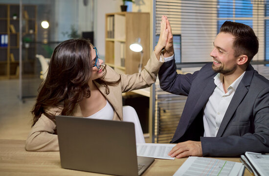 Client broker colleague highfive in office consulting. They celebrate success, finalize agreement and close deal with teamwork. Trusted service. Strong concept of winning collaboration.