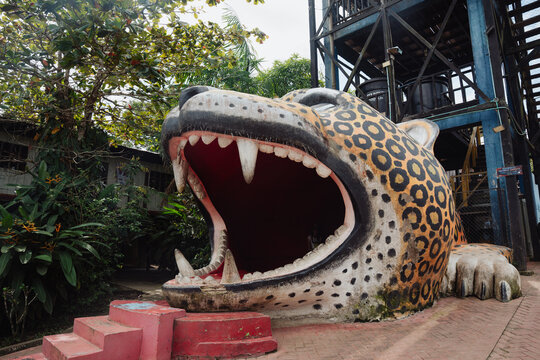 Jaguar figure next to a tower.