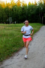 Adult European Woman Running in Open Stadium.  © Anton Belovodchenko