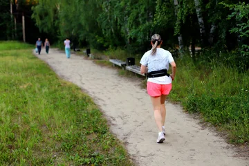 Adult European Woman Running in Open Stadium.  © Anton Belovodchenko