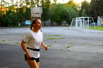Adult European Woman Running in Open Stadium.  © Anton Belovodchenko