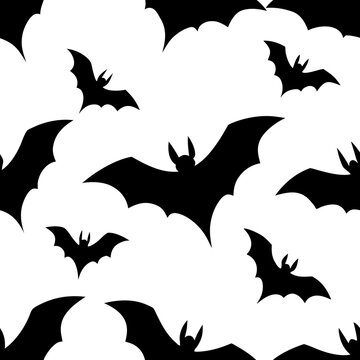 Flying bats seamless pattern spooky halloween background. night creature silhouettes scary dark animal print wallpaper design.