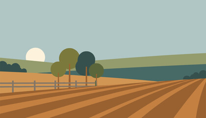 Fototapeta premium Ploughed agricultural field with neat soil rows, green trees, a fence, and a rising sun in the background.