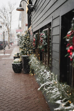 Snowy holiday decorations along a brick sidewalk in downtown Naperville, Illinois