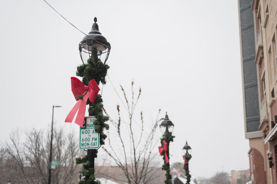 Holiday decorated streetlights and parking sign in downtown Naperville, Illinois