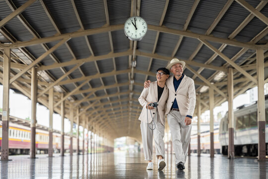 Happy Senior Asian Men Traveling Together at Train Station Platform
