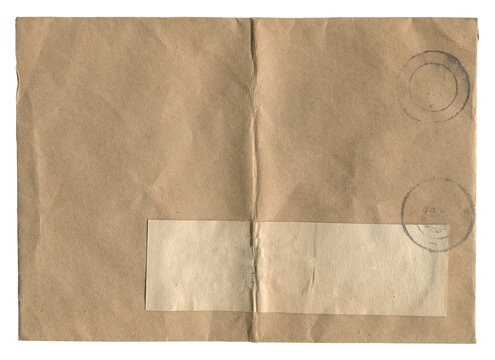 Vintage brown postal envelope with blank address label and faded stamps isolated on white