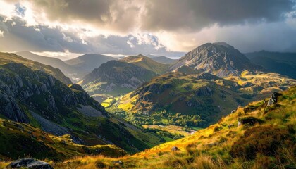 Fototapeta premium Sunlight breaks through clouds over a rugged mountain valley.