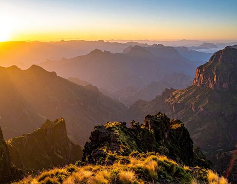 Majestic mountain range bathed in the golden light of sunrise.