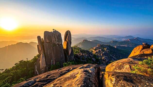 Sunrise illuminating a majestic rocky mountain landscape.