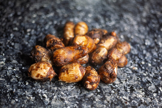 Boiled taro roots on black marble countertop