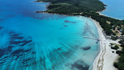 Rondinara Beach aerial view - pier turquoise water sandy beach and pine headland Corsica drone © loiclgc