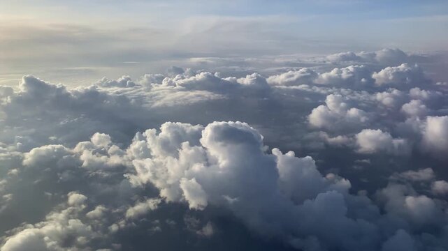 Overhead aerial view of extensive bright cumulus and stratus cloud formations creating a textured blanket, with no visible ground or human activity.