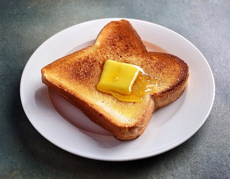 golden toast with butter and honey white plate