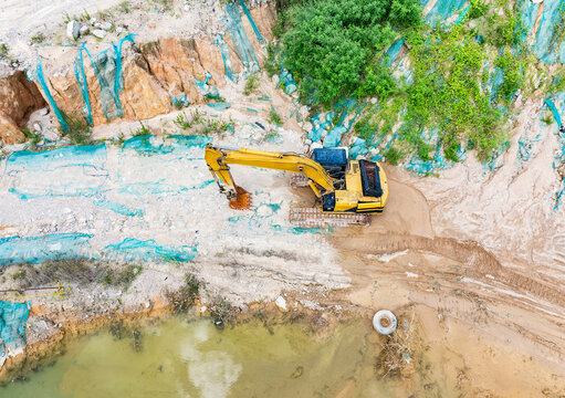 Drone view over excavator for sand and crushed stone loading