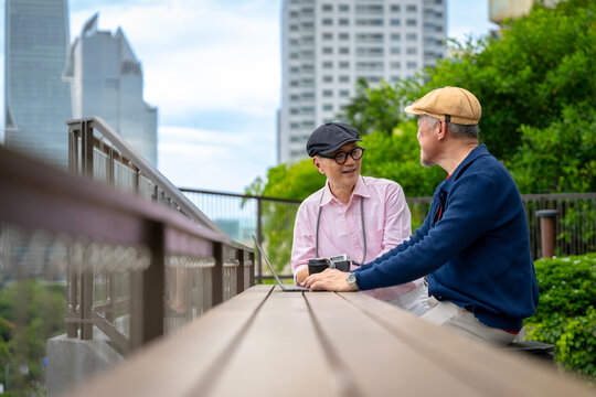 Active Senior Asian Men Using Laptop and Chatting at Outdoor City Park, Stock Photo